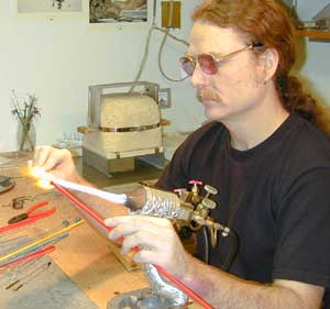 Chuck Pound making glass marbles at the torch
